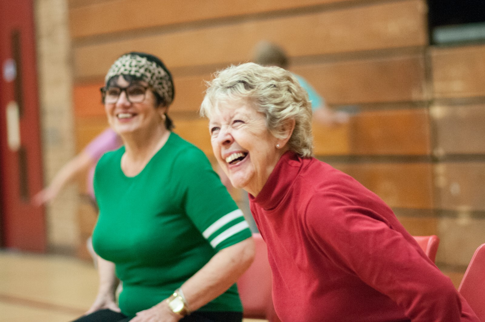 Two ladies sitting laughing and smiling.jpg