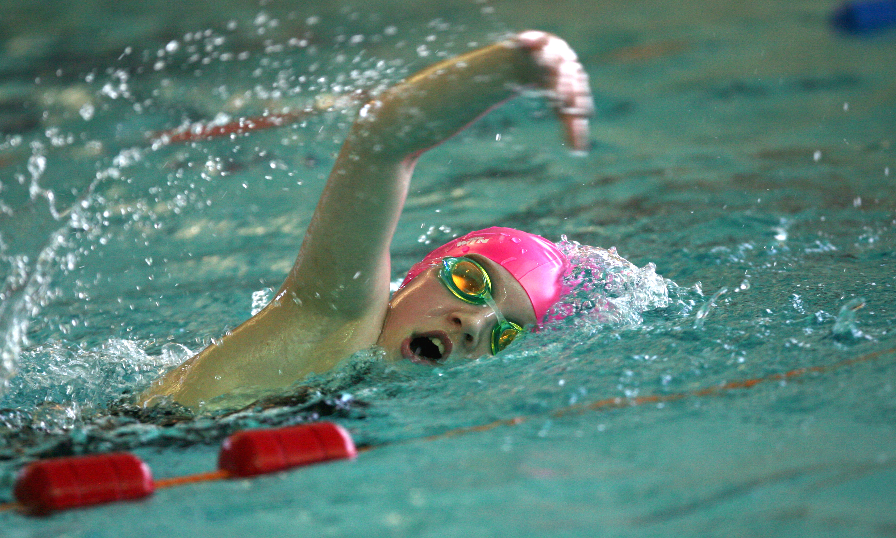 Child in Pink Swim Cap doing front crawl